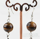 Dangle style round tiger eye earrings with long tail