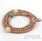 Faceted Sun Shone Beaded Stretch Bracelet with Corozo Nut Buddha's Head and Turquoise and Sterling Silver Elephant Accessory ( Can also be Necklace )
